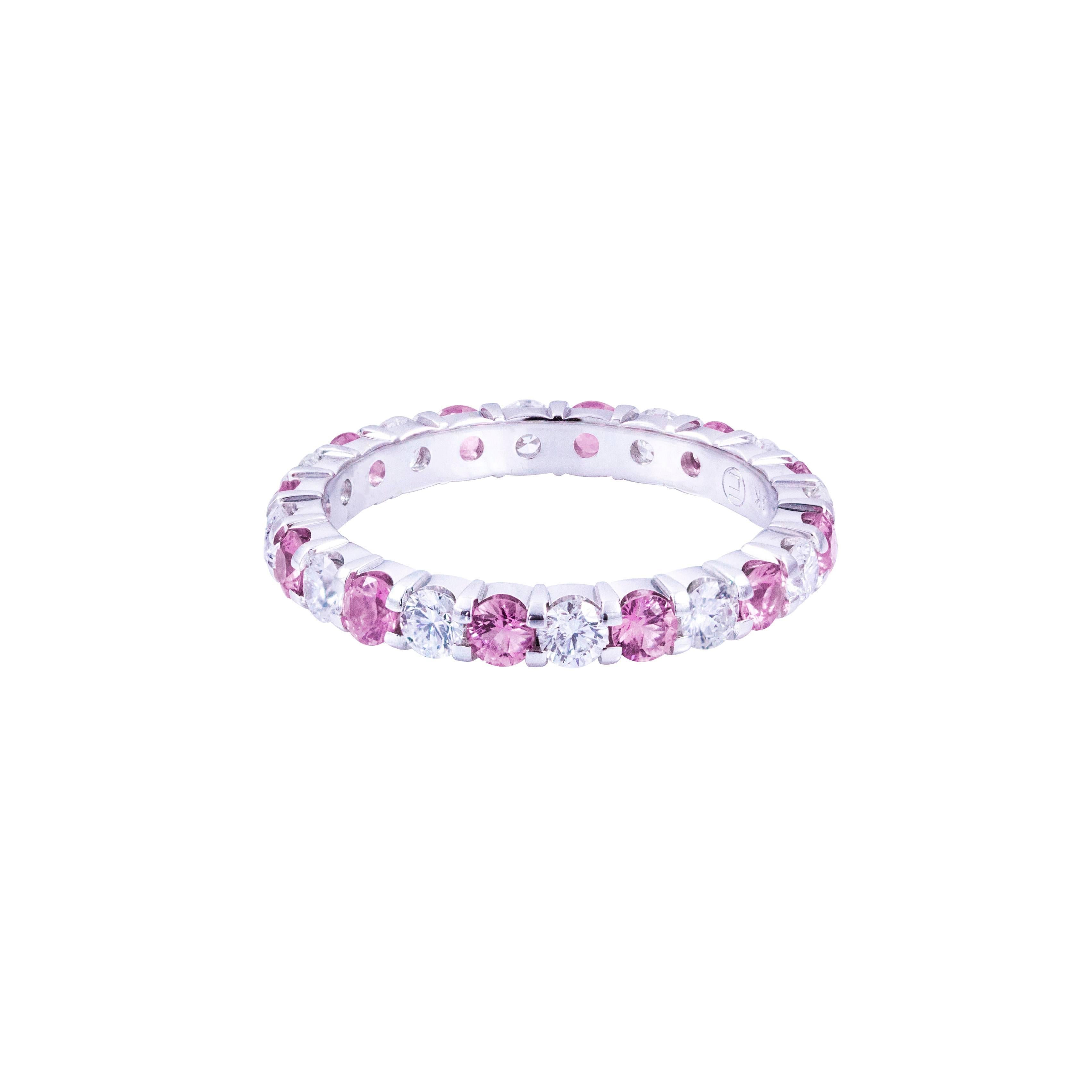 This gorgeous ring is set 12 natural pink sapphires weighing 1.14 carats that alternate with 12 round brilliant diamonds weighing 0.90 carats total. Set in 18k white gold. Size 7 US.

Style available in different price ranges. Prices are based on