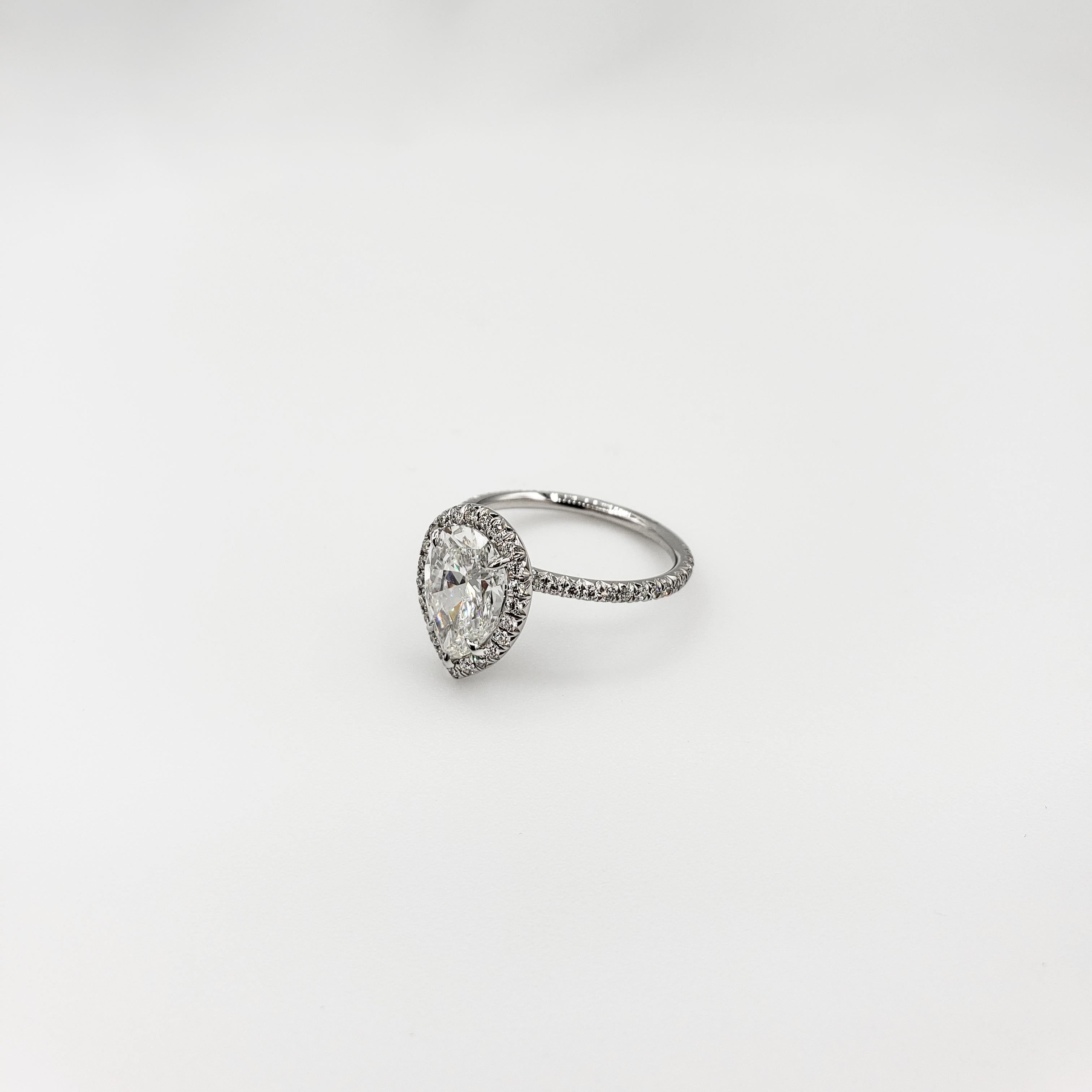 Halo engagement ring design showcasing a 2.01 carat pear shape diamond center stone in a diamond encrusted surmount. GIA report: I color, VS1 clarity. Set in a french pave set diamond band in platinum. Accent diamonds weigh 0.40 carats total. 

