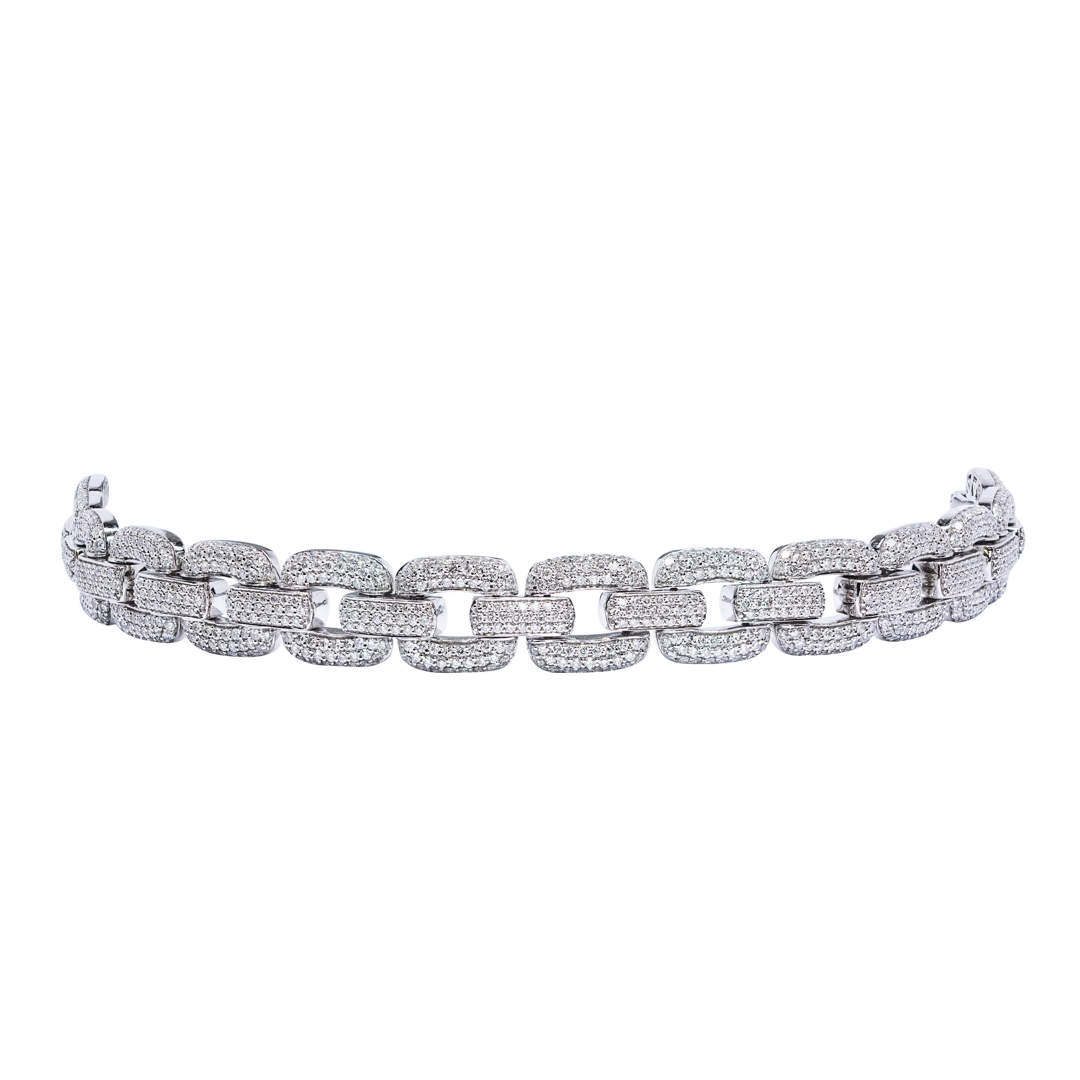 A stunning link bracelet with micro-pave set round brilliant cut diamonds of 6.55 carats total. The diamonds are approximately F color and VS clarity. Set in 18K white gold, this bracelet measures about 7 inches in length and 0.45 inches in width. A