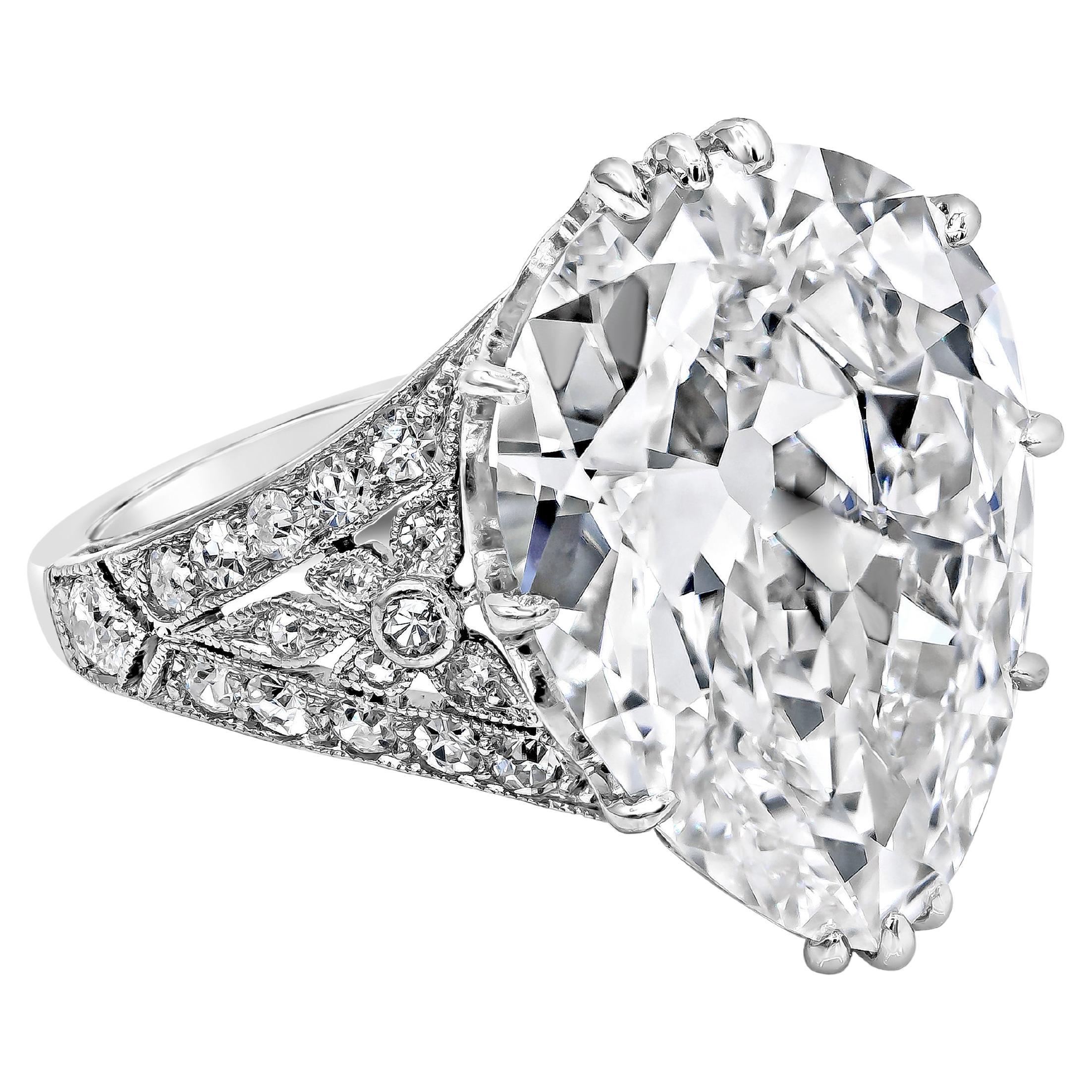 A gorgeous and unique ring showcasing a GIA Certified 7.03 carat pear shape diamond, G Color and VVS1 in Clarity. Set in an antique setting accented with 34 single cut diamonds weighing 0.37 carats total. Made with Platinum. Size 6 US