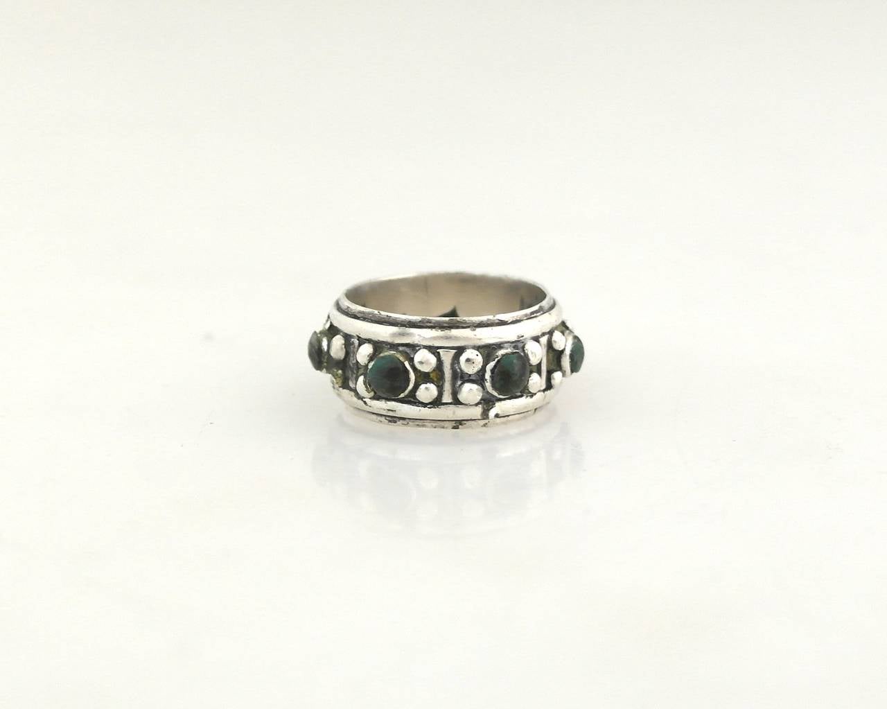Being offered is a .970 silver ring by Antonio Pineda of Taxco, Mexico. Band ring decorated with beaded accents & applied Mexican jade stones. Dimensions:     Marked as illustrated. In excellent condition.

Stanley Szaro Antonio Pineda