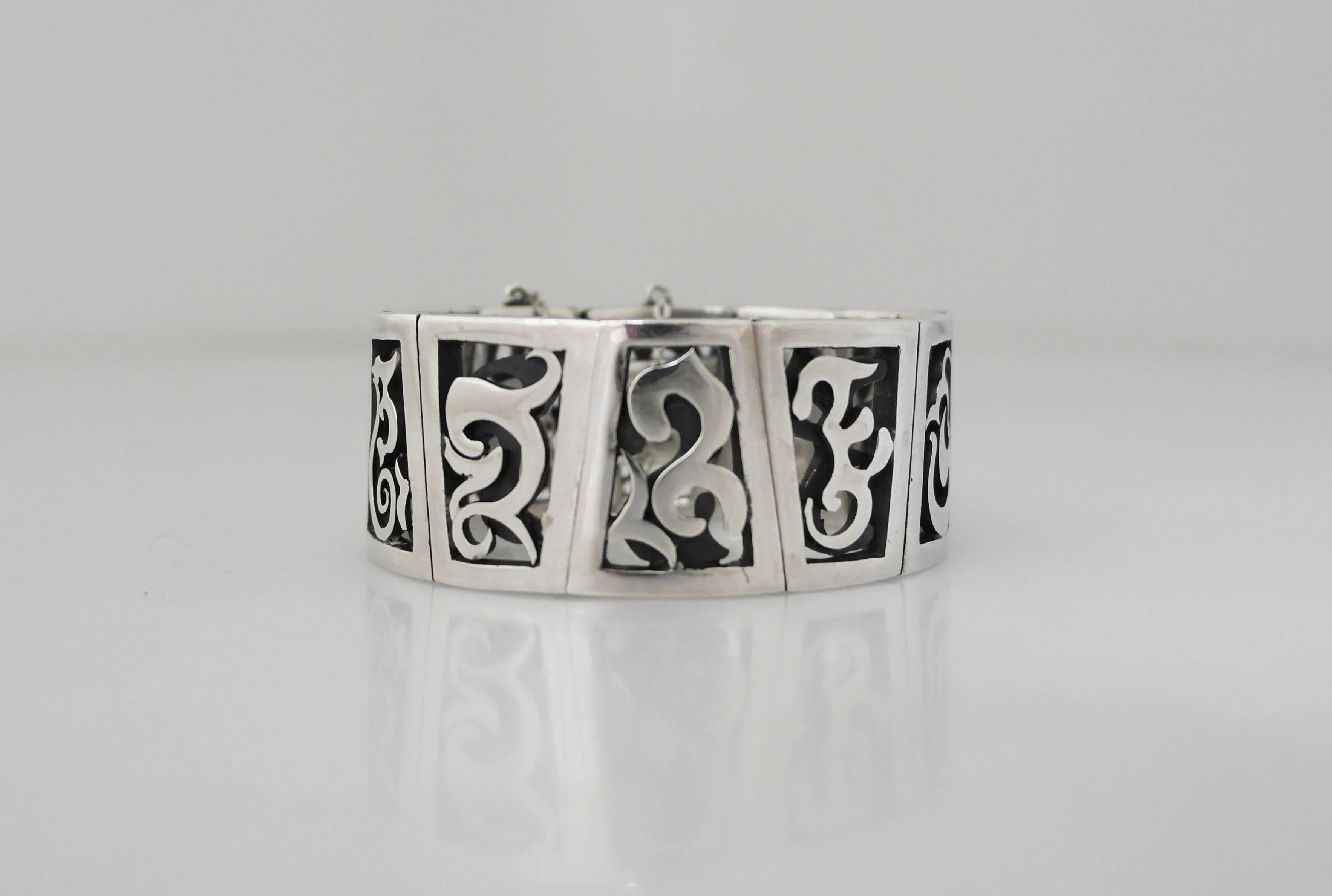 Being offered is a sterling silver bracelet made by Antonio Pineda of Taxco, Mexico. Scarce bracelet with hand pierced links, each with a slightly different motif. Dimensions: Wearable - 6 1/2 inches x 1 inch wide. Marked as illustrated. In