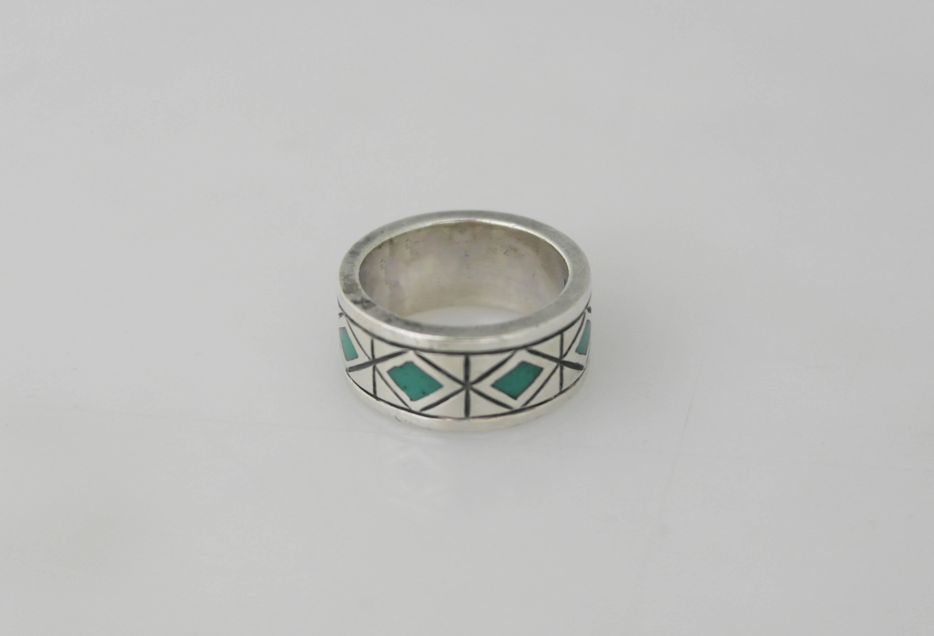 Being offered is a sterling silver ring made by Los Castillo of Taxco, Mexico. Comprising a diamond pattern with incised detail & turquoise stone inlay. Dimensions: 1/2 inch wide; size 9 1/2. Marked as illustrated. In excellent condition with normal