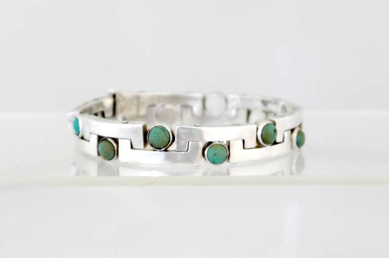 Being offered is a circa 1960s .970 silver modernist bracelet by Antonio Pineda of Taxco, Mexico. Interlocking links decorated with Mexican jade stones; tongue & box closure. Length 8 1/4