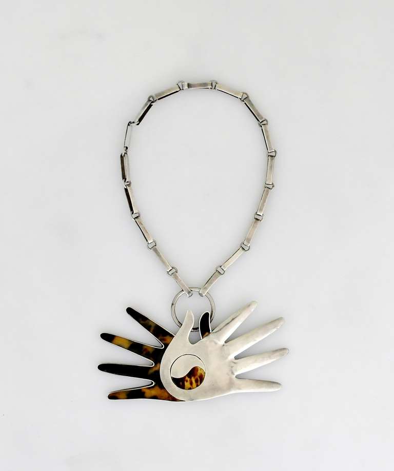 Being offered is a rare circa 1951 necklace by William Spratling of Taxco, Mexico. Necklace with one shell & one silver hand; a ying yang applied motif at the center; attached to a silver link chain. Dimensions:  necklace 16 1/2 inches long (inner