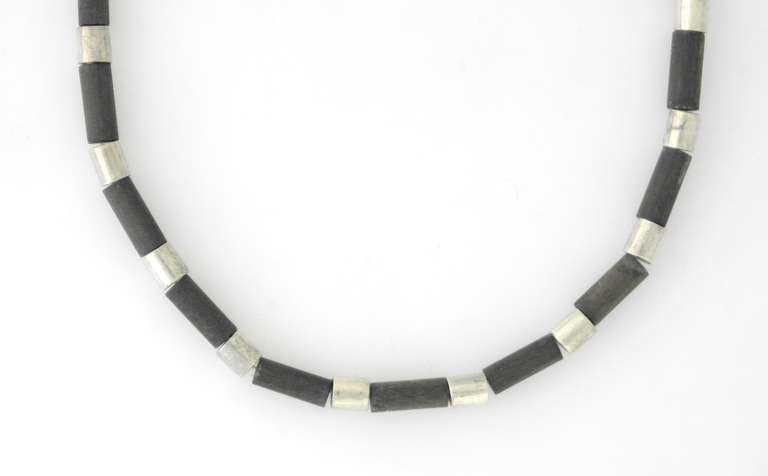 Being offered is a circa 1953 sterling silver and rosewood necklace by William Spratling of Taxco, Mexico. Made during his third design period (1951-1967), tube necklace with carved rosewood & silver; tongue & box closure. Dimensions: 16 1/2