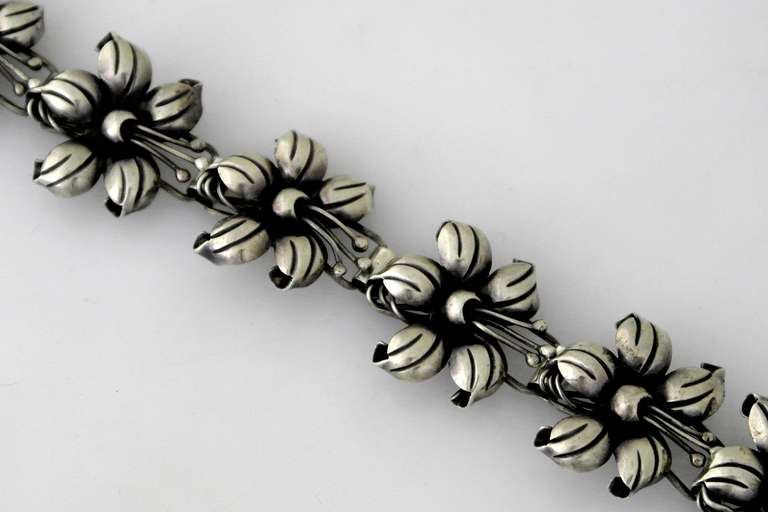 Being offered is a circa 1940s .980 silver bracelet from Taxco, Mexico. Handmade--incredibly chased--three dimensional floral motif links. Dimensions: 7