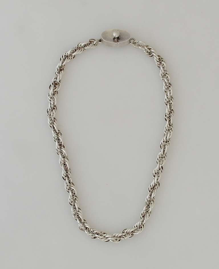 Being offered is a circa 1955 .970 silver (better than sterling) necklace by Antonio Pineda of Taxco, Mexico; chain necklace made of several multi-layered circular rings; oval shaped ball clasp. Dimensions: 18 inches long. Weight shy of 2 ounces.