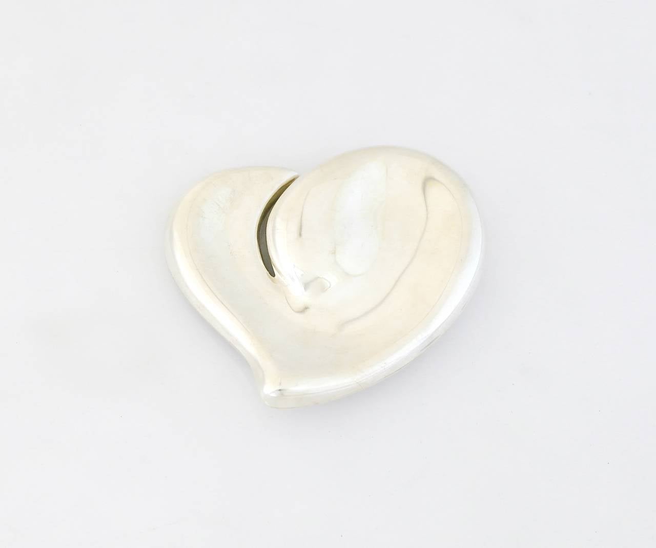 Being offered is a circa 1978 sterling silver belt buckle designed by Elsa Peretti for Tiffany & Co., comprising a figural modernist heart shaped form produced in Italy. Dimensions: 4