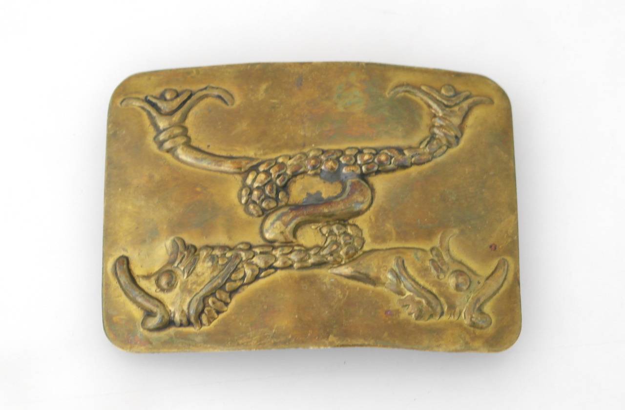 Offering a scarce brass belt buckle by Hubert Harmon of Taxco, Mexico. Made entirely of brass with embossed koi fish as the primary decorative element. Harmon only lived in Taxco a short while and was known for his whimsical design. His work is