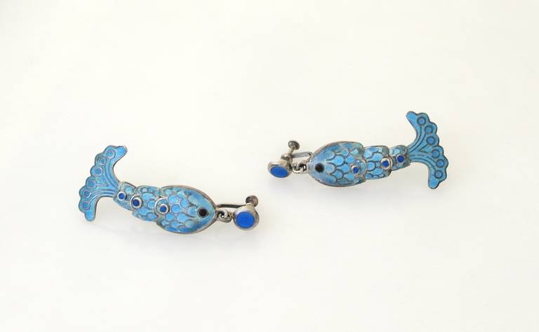 Being offered is a circa 1961 jewelry suite by Margot de Taxco with blue enamel wave and fish design, necklace secured with bow clasp, bracelt secured with box clasp and chain, screw backs to earrings.  Necklace 17 5/8 inches long (inner