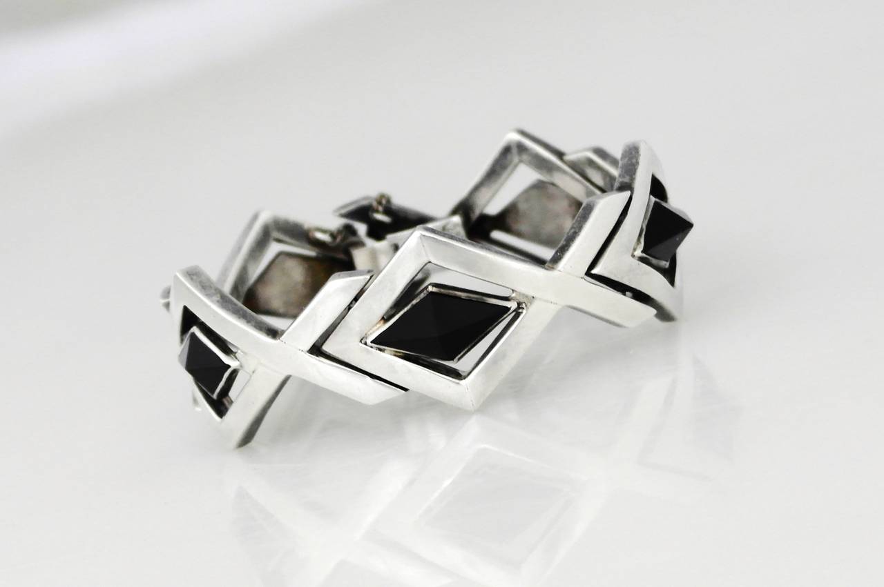 Being offered is a .970 silver bracelet by Antonio Pineda of Taxco, Mexico. Comprising diamond shape links with bezel set diamond shape onyx stones on each link; tongue & box closure with security chain. Dimensions: wearable 7