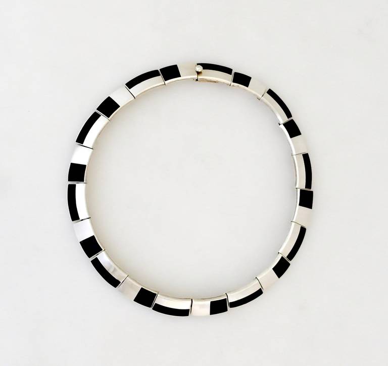 Being offered is a choker necklace by Antonio Pineda of Taxco, Mexico, in an art deco style, using onyx to highlight this motif.  Dimensions 16 inches.  Marked.  In excellent condition.

Stanley Szaro Antonio Pineda Collection

In the mountain