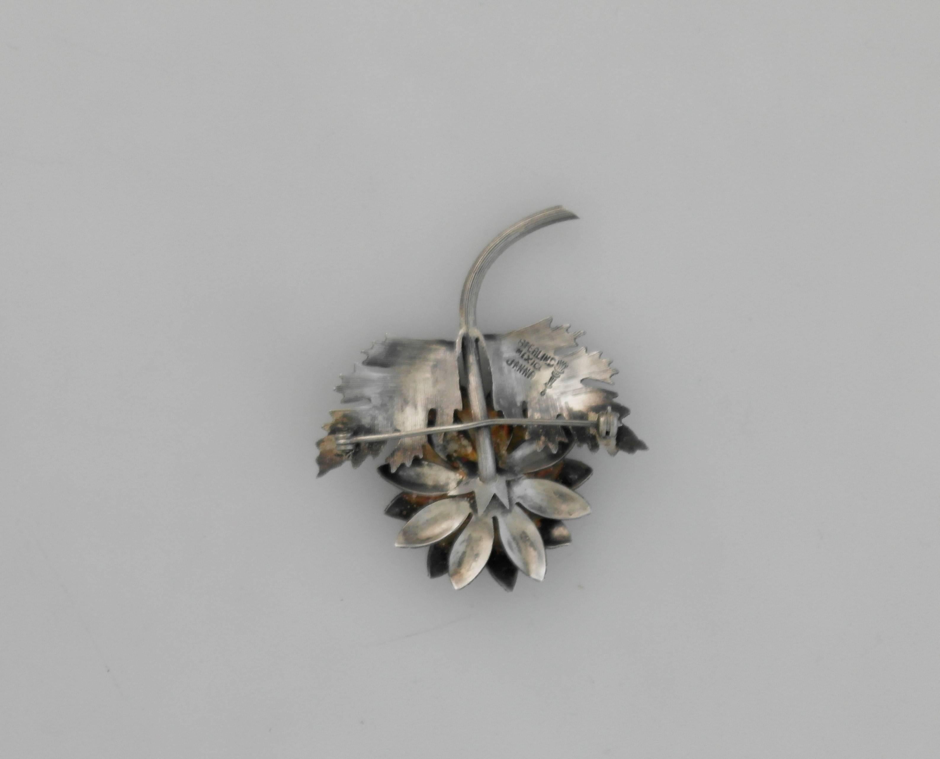 Being offered is a sterling silver pin by Janna Thomas of Taxco, Mexico. Entirely hand made object in the form of a flower with intricate detail on the leaves, petals and stem. Thomas designed for Tiffany & Company before opening her own shop in