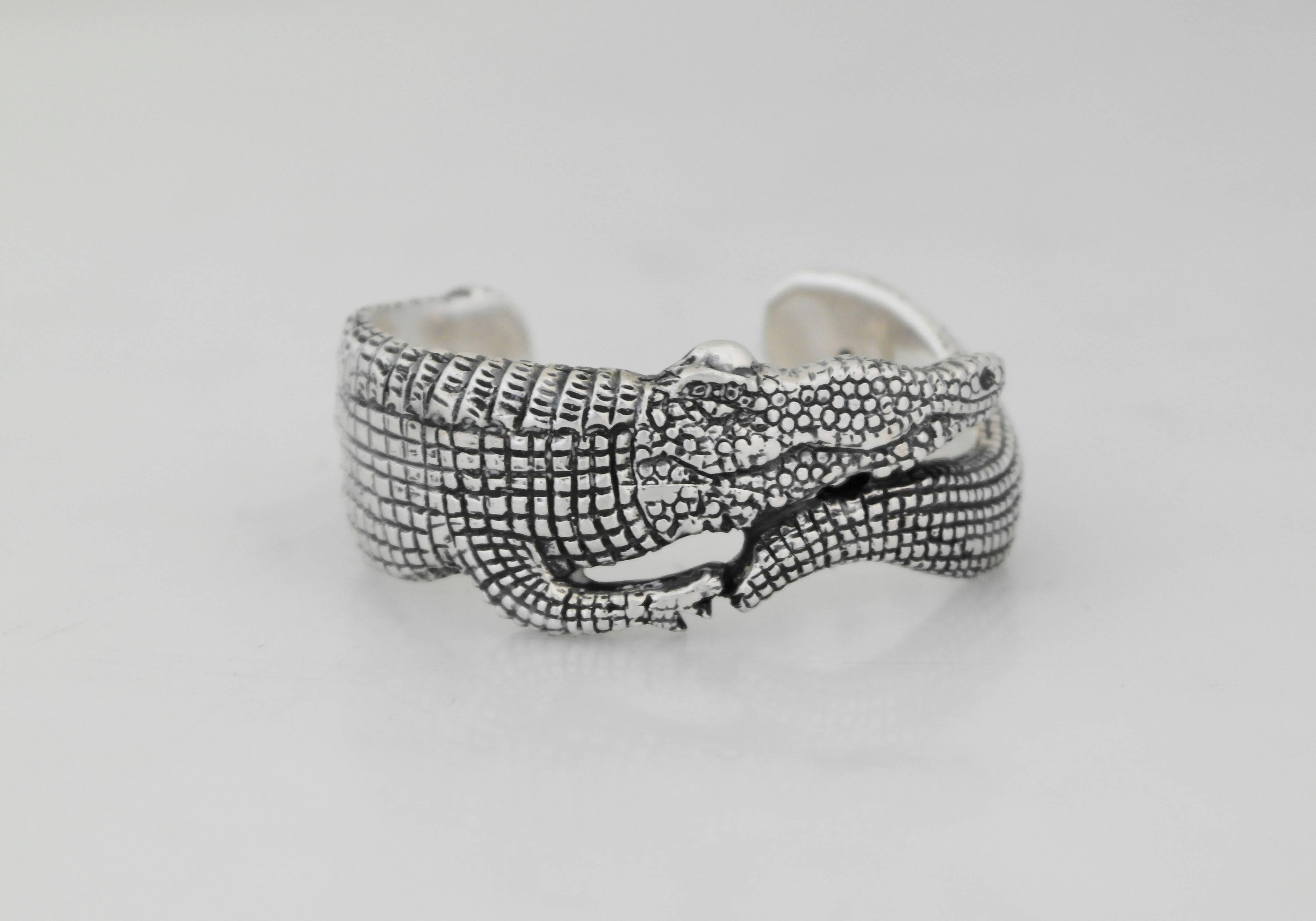 Being offered is a sterling silver cuff bracelet by Emilia Castillo of Taxco, Mexico. Cuff in a figural alligator motif with a textured design. Dimensions: wearable 6 1/2 inches x 1 inch wide x 1 inch opening. Marked as illustrated. In excellent