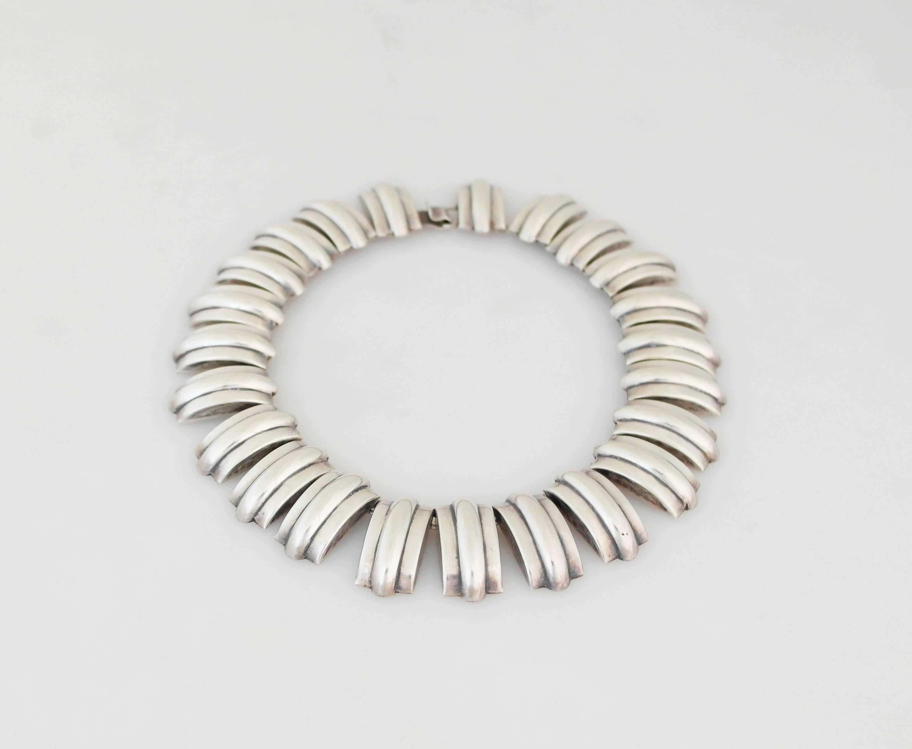 Being offered is a circa 1940 sterling silver necklace designed by Fred Davis for Sanborn's of Mexico. Art Deco inspired piece; each link attached by 'o' rings; secured by a tongue & box closure. Dimensions: wearable 14 inches x 1 inch wide. Marked