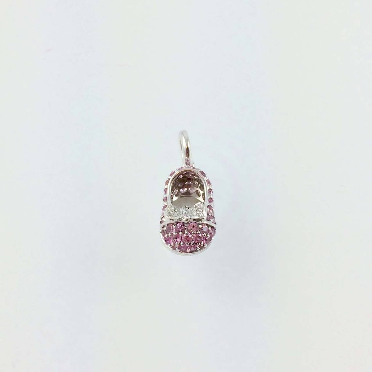 Aaron Basha 18K white gold, prong set with pink sapphires and diamond bow pave set with full cut round diamonds, G color, VS clarity suspended from 18K white gold bale.
Retail $4600