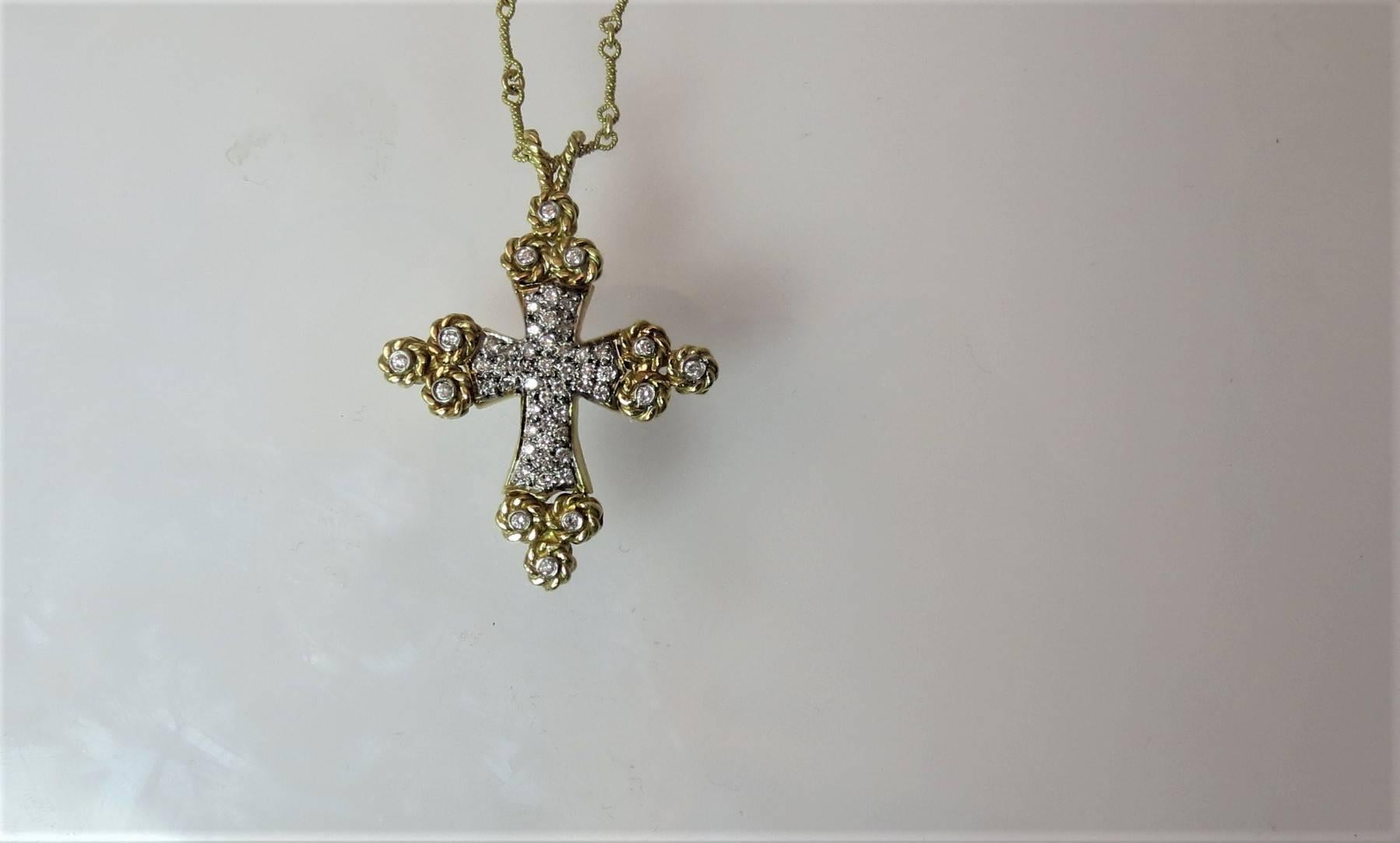 Cassis 18K yellow gold and diamond cross pendant set with 51 full cut round diamonds weighing .77cts suspended from 18 inch yellow gold chain.