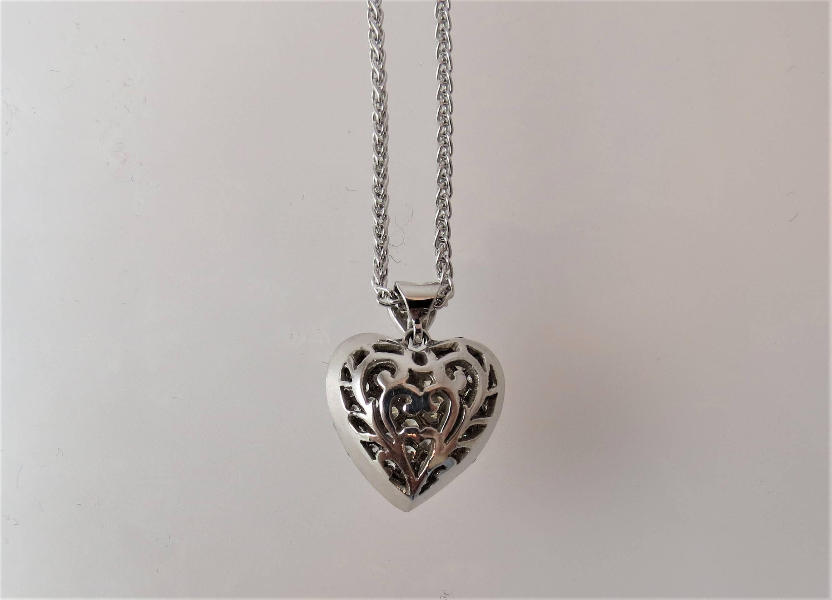 Beautiful 18K white gold diamond double heart pendant, set with 56 full cut round diamonds weighing 1.28cts total, suspended from diamond bale and 17 inch white gold chain