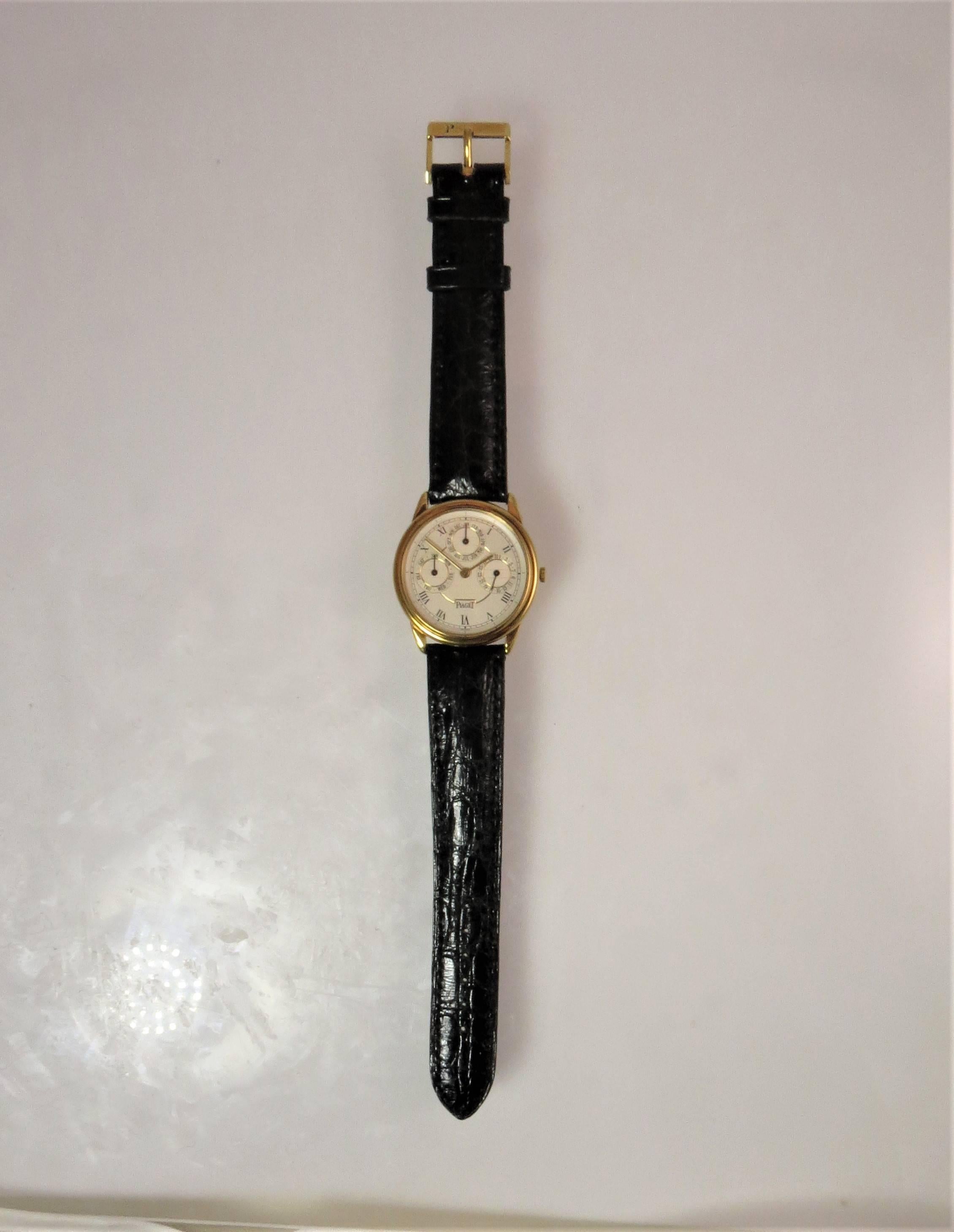 Brand new, never worn, 18K yellow gold Piaget Automatic strap watch, silver textured dial, automatic movement, case size 31mm, three subdials showing month, date and day, 18k yellow gold Piaget buckle, model 15959Y, serial #553737.
Last retail