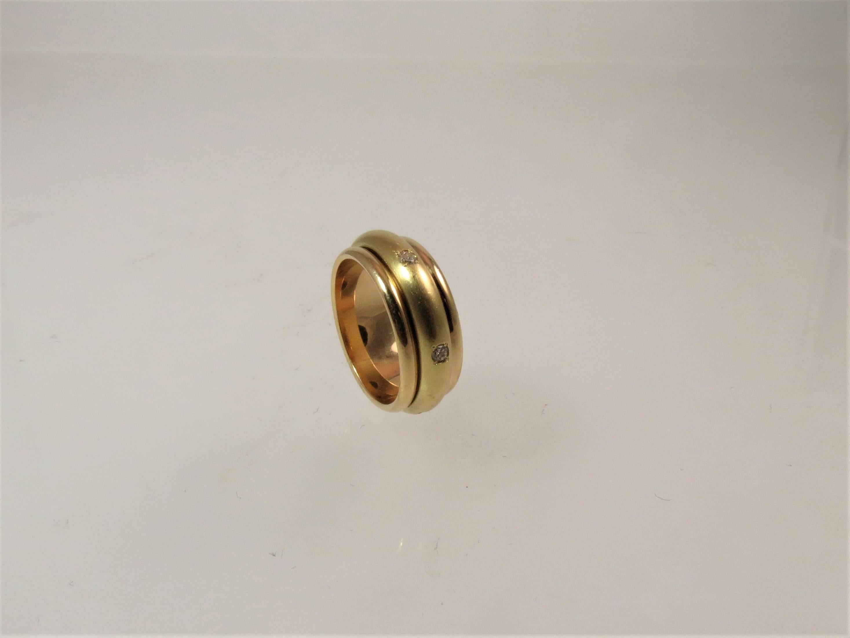 bague à anneau en or jaune 18K avec anneau central en diamant, serti de 6 diamants ronds pleine taille pesant .24cts, largeur 8mm.
Taille 7.25