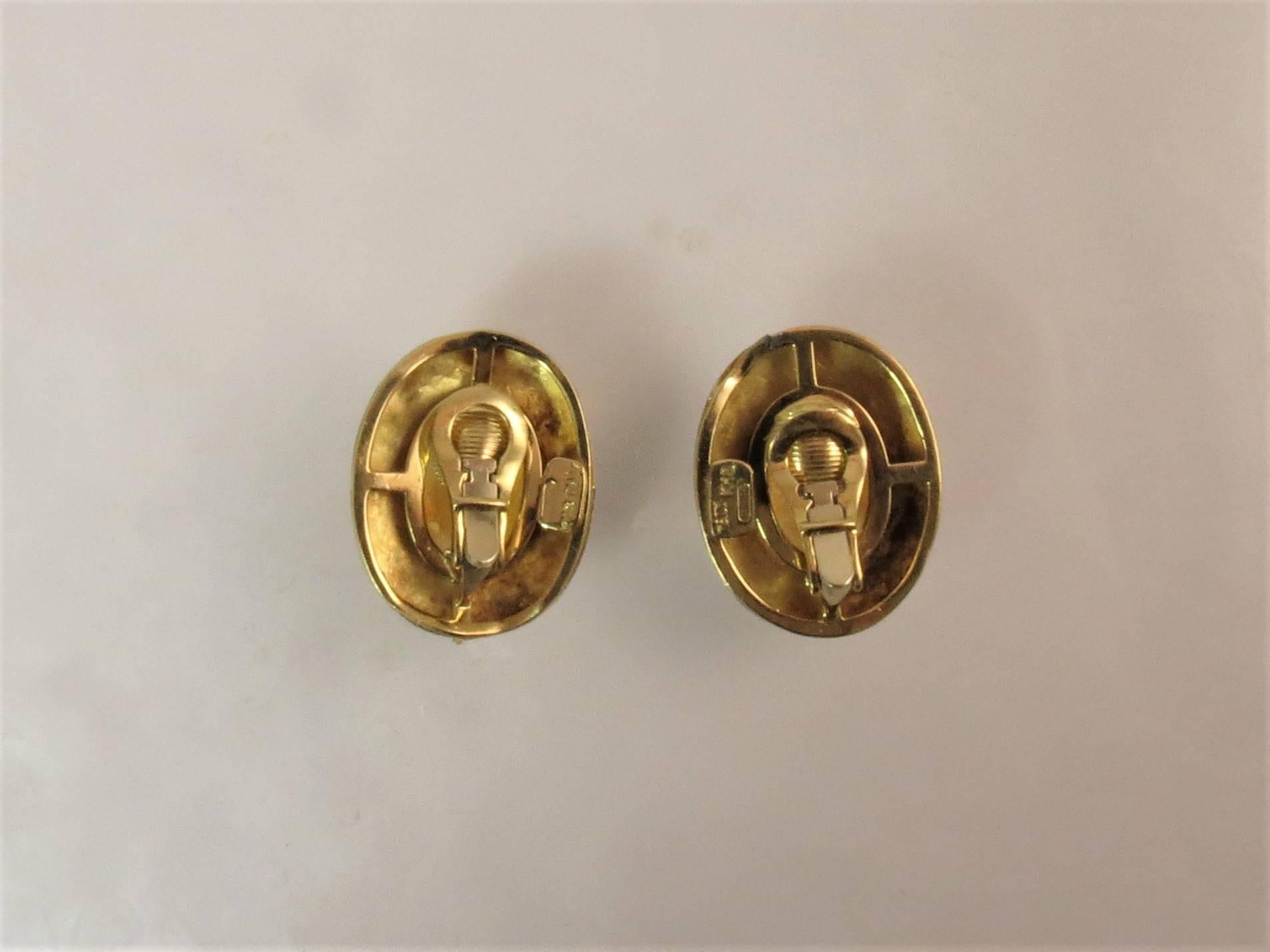 Dramatic 18K yellow gold textured ear clips with oval cabochon citrine in center.  