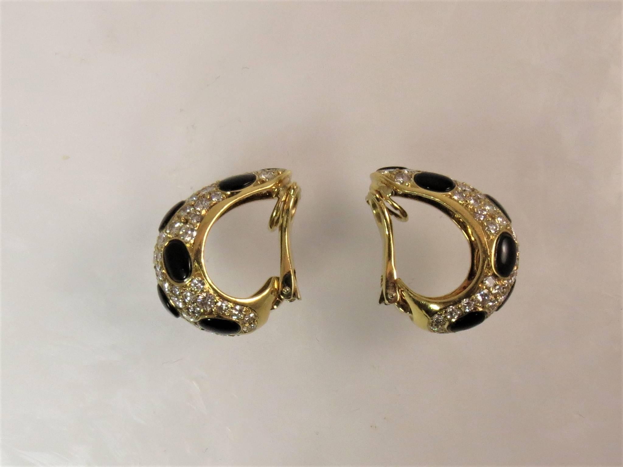 18K yellow gold ear clips set with145 full cut round diamonds weighing 5.48cts F-G color, VS clarity, and 18 cabochon black onyx sections.