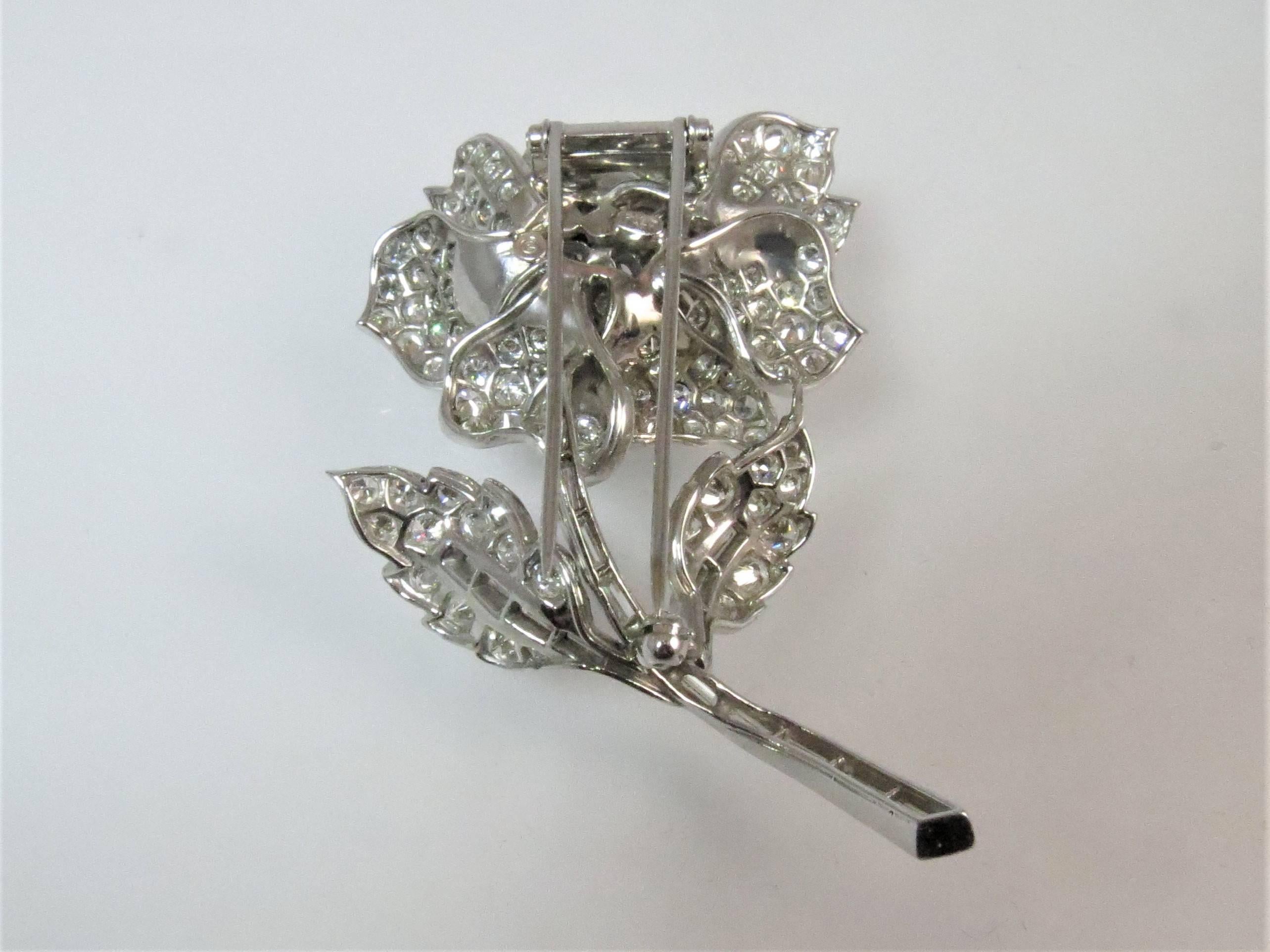 Platinum flower pin with double hinged back, set with 173 full cut round diamonds and 17 baguette diamonds  weighing 12.50cts total, F-G color, VS-SI1 color