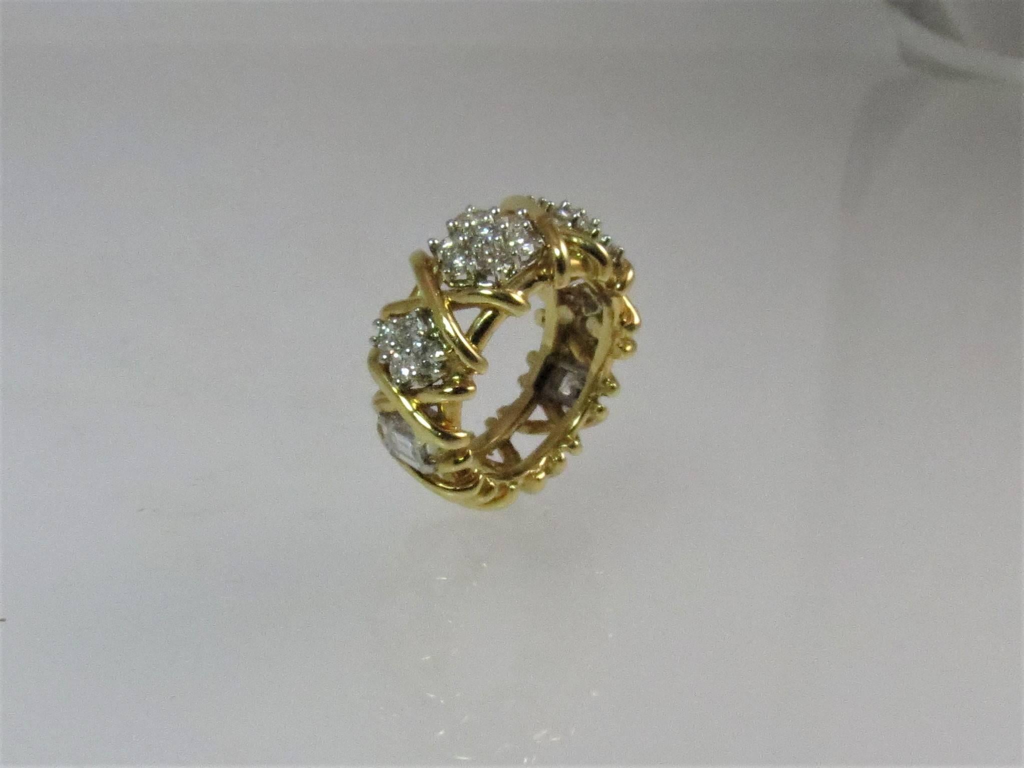 Stunning 18K yellow gold and diamond band ring set with 22 full cut round diamonds weighing 1.48cts F-G color, VS clarity and 2 step cut diamonds weighing .70cts F-G color, VS clarity
Finger size 6.