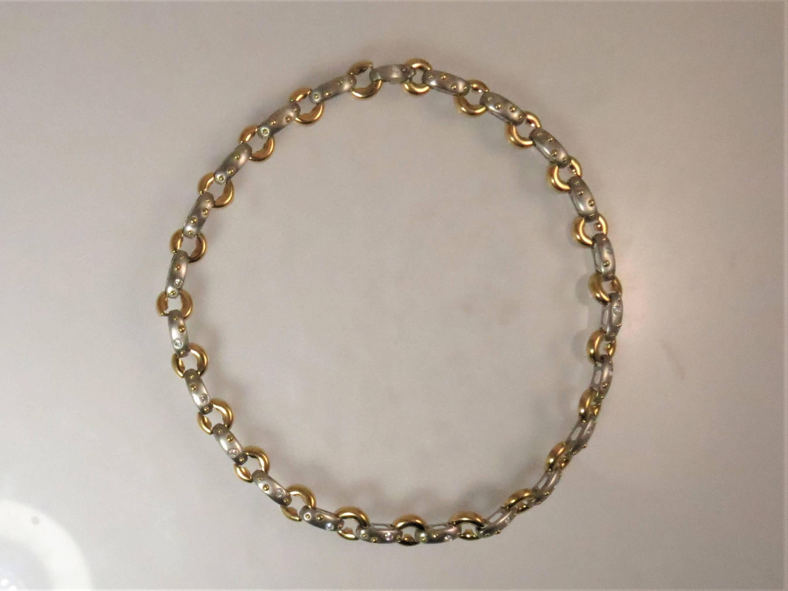 Fabulous 18K bright finish yellow gold and satin finish platinum necklace with circle design set with 14 full cut round diamonds weighing .77cts, G-H color VS clarity