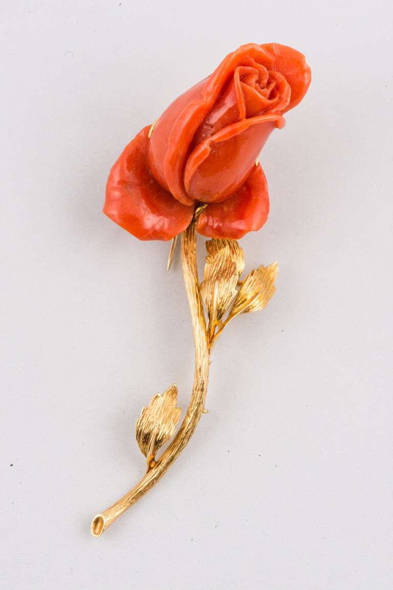 Signed David Webb 18k yellow gold, carved coral rose with a textured 18K yellow gold stem, double clip pin.