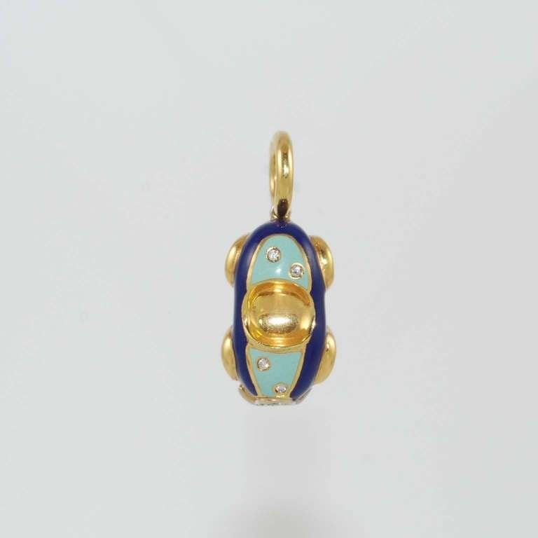 Aaron Basha 18K yellow gold, light blue and dark blue enamel car charm with four round diamonds, G color, VS clarity weighing .11 carat total and four round cabochon blue sapphire wheels weighing .32 carats total suspended from a 18K yellow gold
