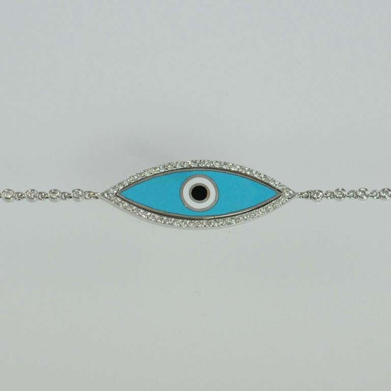 Aaron Basha Evil Eye Bracelet, 18K white gold bracelet bezel set with round diamonds and marquise shape light blue evil eye surrounded by bead set diamonds, G color, VS clarity, weighing .57 carats total,  7 inches.