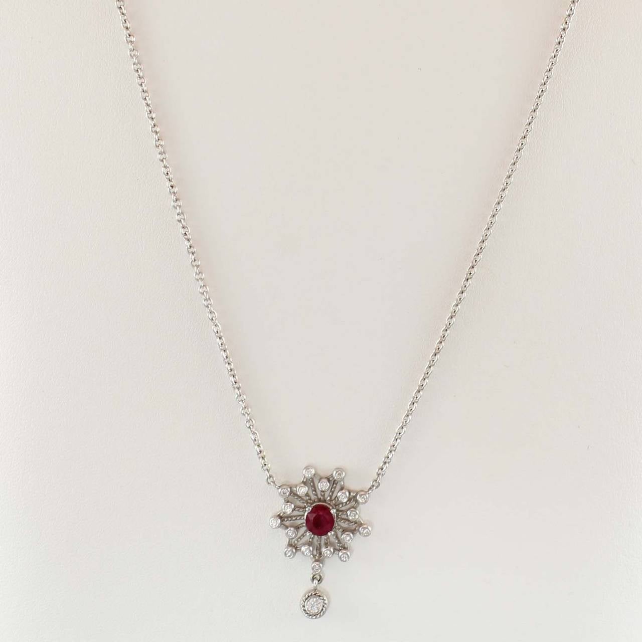 Doris Panos Star Drop Pendant, Lucia Collection,  set with one round faceted red ruby weighing 1.10 carats, and 19 full cut round diamonds weighing .30 carats total suspended from a 16 inch 18K white gold cable link chain.