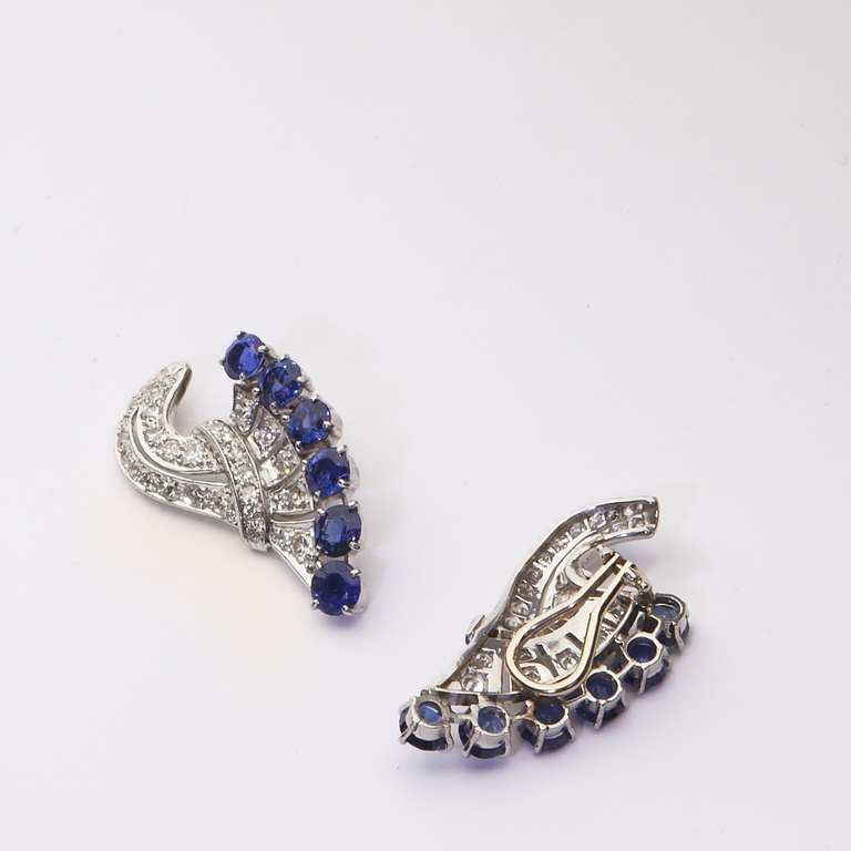 Art Deco diamond and blue sapphire ear clips,  bead set with 64 full and single cut round diamonds, GH color, VS clarity, weighing about 1.85 carats and 12 prong set round faceted blue sapphires weighing about 6 carats.