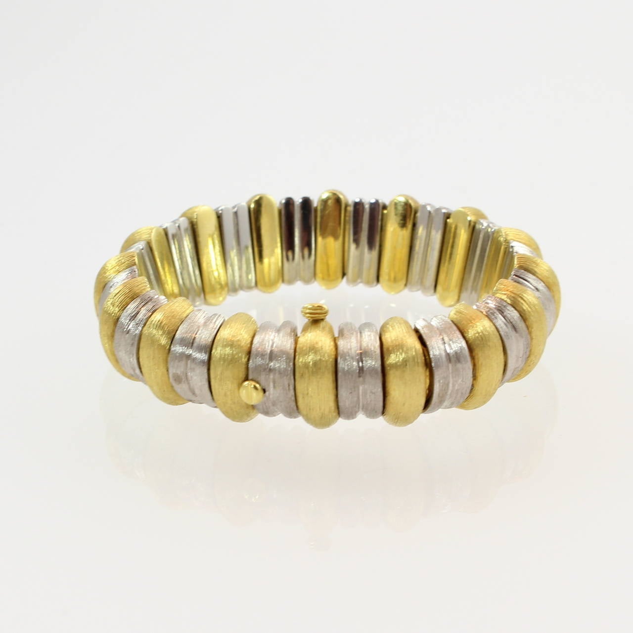 Henry Dunay Platinum and 18K yellow gold  Sabi finish flexible bracelet.
Bracelet is 7 inches long and .63 inches wide.