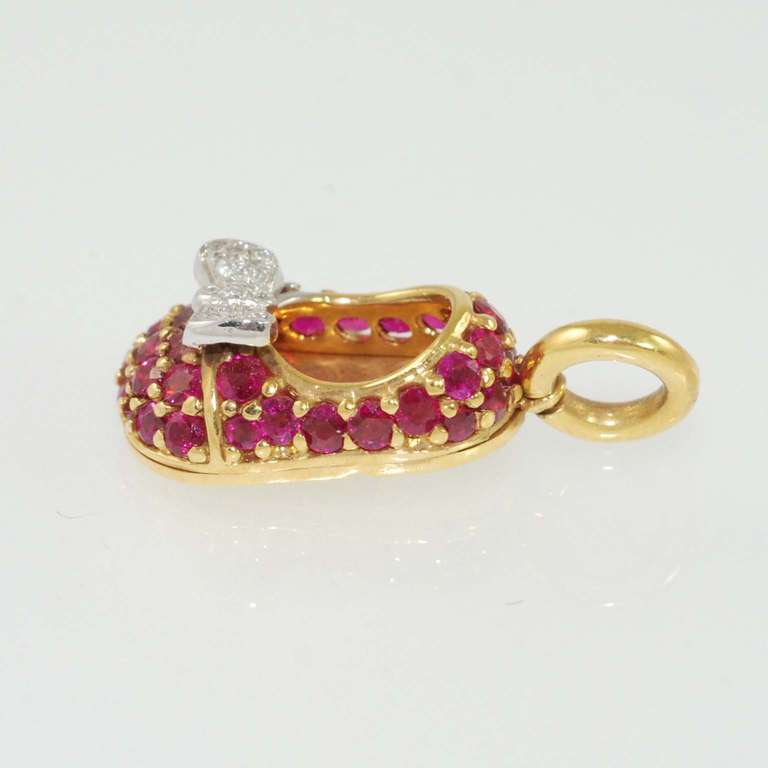 Aaron Basha 18K yellow gold, prong set with rubies and diamond bow pave set with full cut round diamonds G color, VS clarity suspended from 18K yellow gold bale.