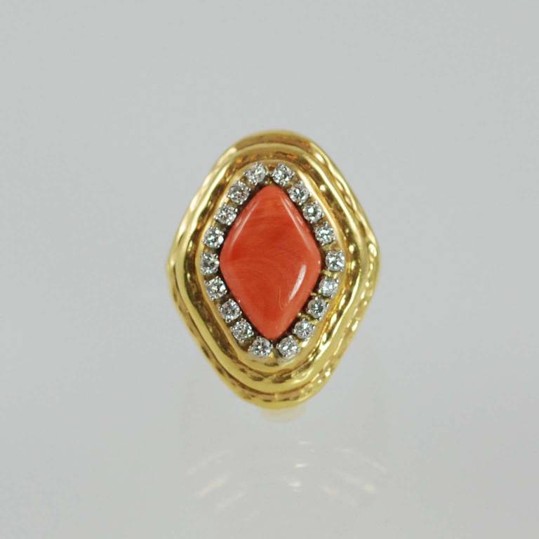 Charles Turi 18K hammered yellow gold salmon coral and diamond ring prong set with 18 full cut round diamonds weighing .60 carats total surrounding polished salmon coral.

Finger size 5.5. May be sized.
