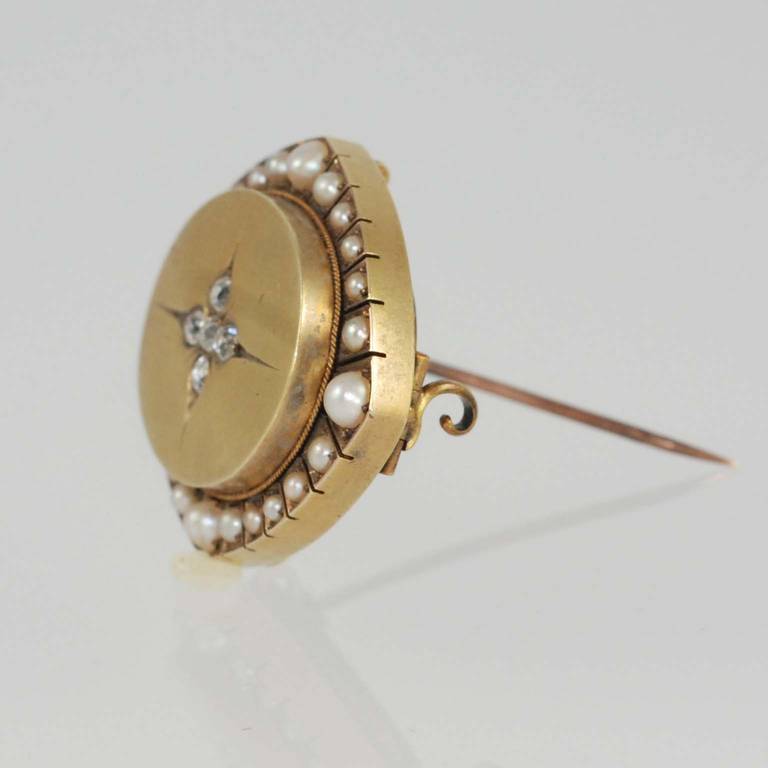 15K yellow gold, pearl and diamond Victorian pin, set with 24 natural pearls and  5 rose cut diamonds measuring approximately 3.5 mm each, with a convertible loop in the back to also be worn as a pendant.