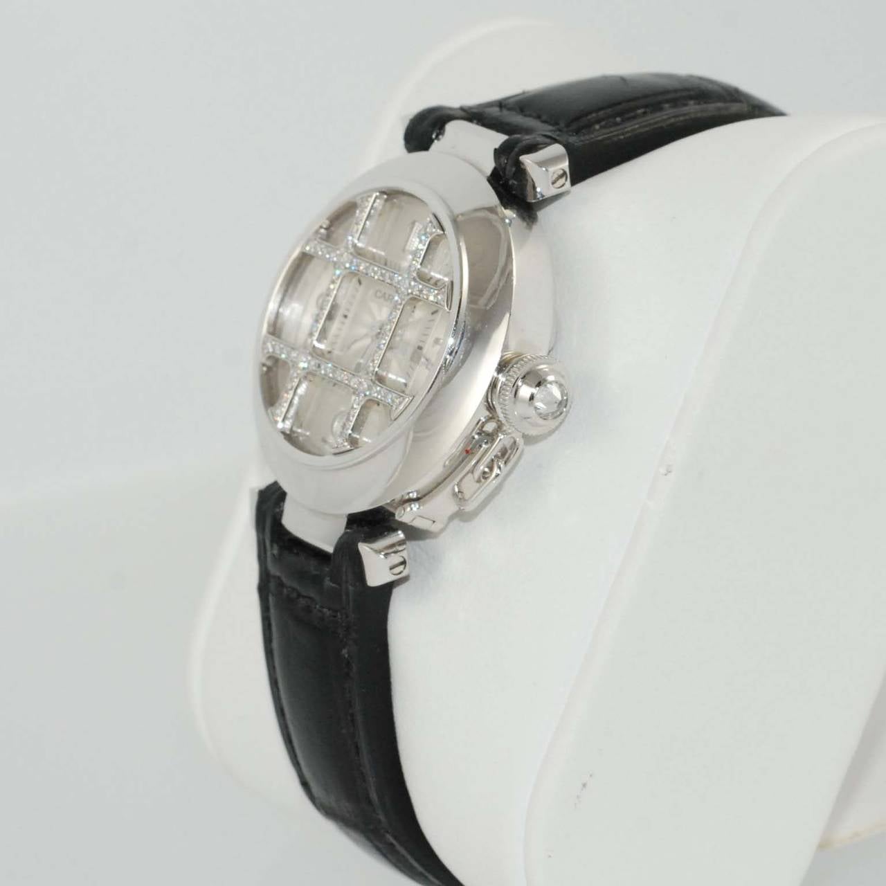 Cartier lady's 18k white gold Pasha wristwatch with removable diamond grid, 32mm, automatic movement, white dial, white gold numerals at 12, 3, 6 and 9 on black alligator strap with 18k white gold ardillon buckle.

Brand new in box
Original retail