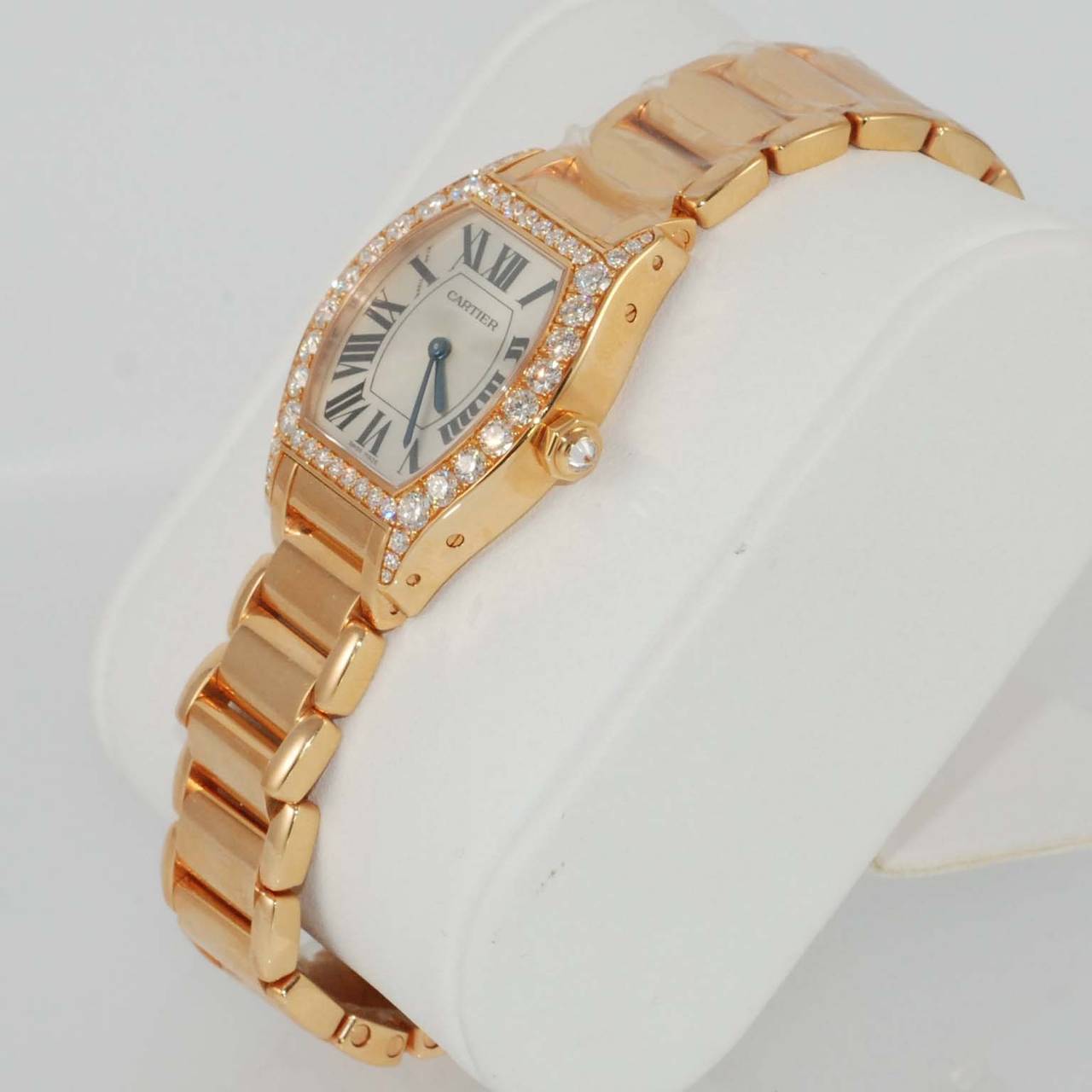 Cartier Lady's 18K Pink Gold Tortue Bracelet Watch, with diamond case with 46 diamonds weighing 1.87 carats, and diamond crown weighing .08 carats, small model, manual movement, silver dial with black Roman numerals. Exhibition back. Like-new in