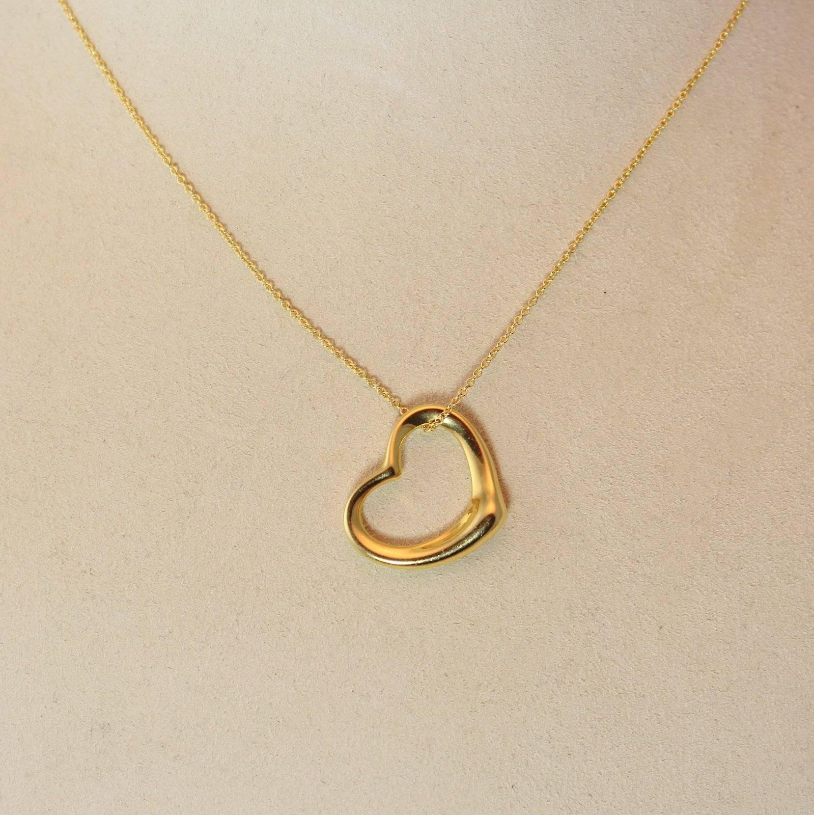 Original Tiffany Elsa Peretti open heart pendant, 18K yellow gold, medium size, on 16 inch 18K yellow gold chain.
Retails at Tiffany for $1550