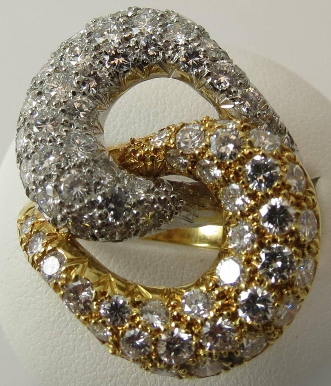 Montreaux platinum and 18K yellow gold double swirl pave diamond ring set with 68 round diamonds weighing 4.70cts, DE color and VVS clarity.
Finger size 6
May be sized