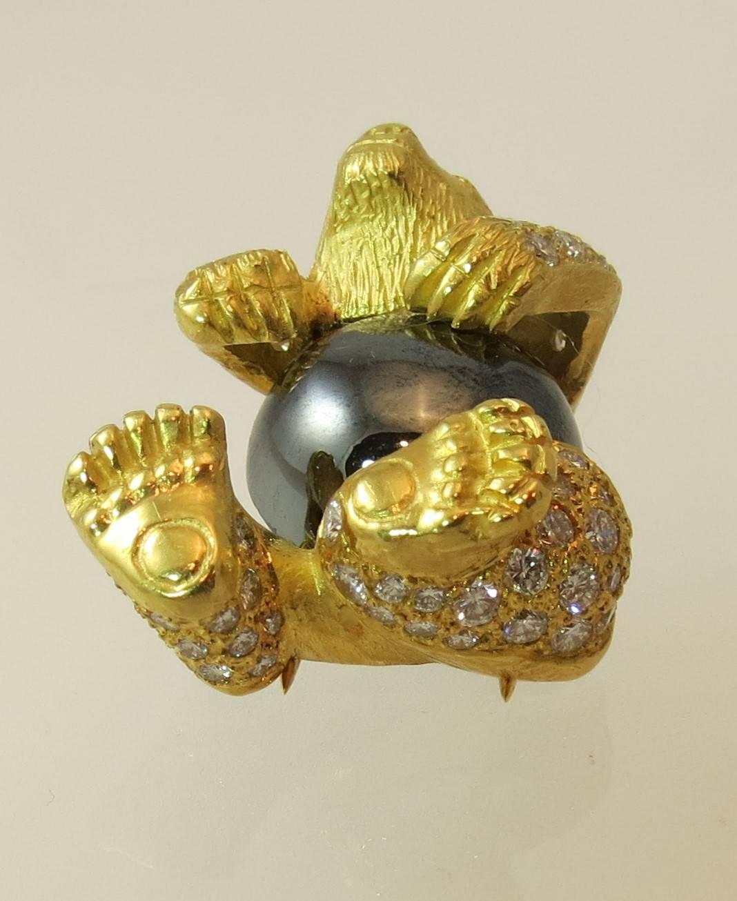 18K yellow gold bear pin, set with 60 round diamonds weighing 3.50cts, EF color, VS clarity, and 2 round green emerald eyes and one domed hematite