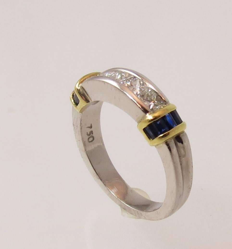 Stunning platinum, 18K yellow gold band ring, channel set with 5 Princess cut diamonds weighing about .65cts, G color, VS clarity, and 10 Baguette blue sapphires weighing about .60cts

Band is 5.65mm
Finger size 6. May be sized