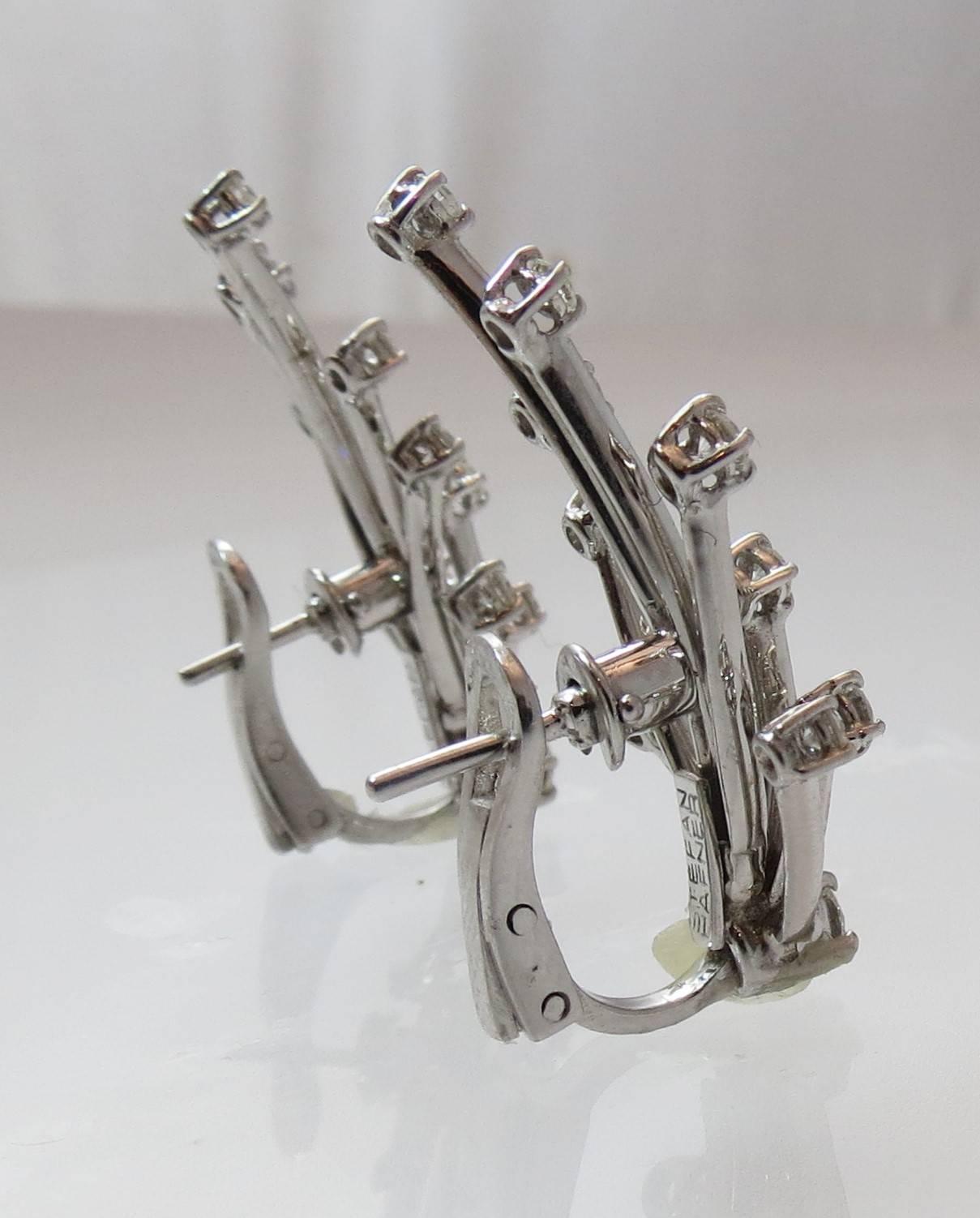 Fabulous 18K white gold diamond spray design earrings, prong set with 22 full cut round diamonds weighing about 1.04 cts total.