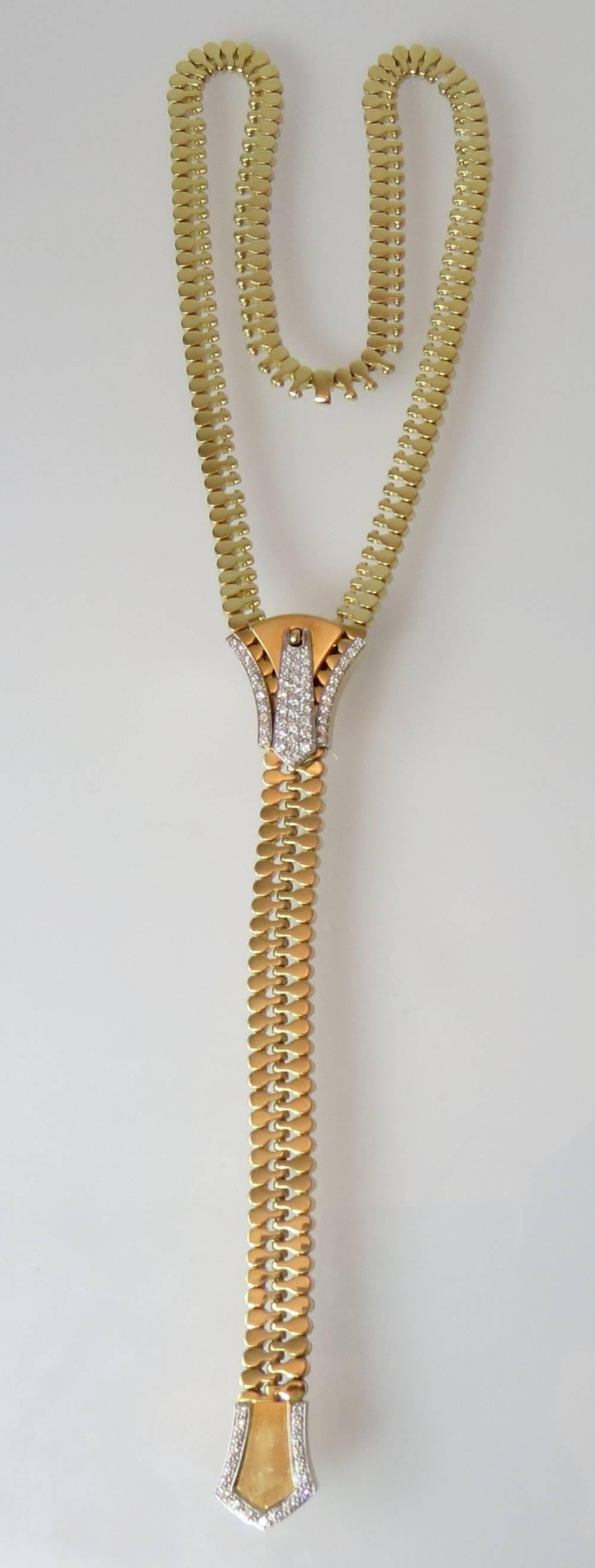 Adjustable and functional 18K yellow gold zipper necklace, set with 66 full cut round diamonds weighing approximately 1.48cts, 28.5 inches long, weighing 117.9 grams.