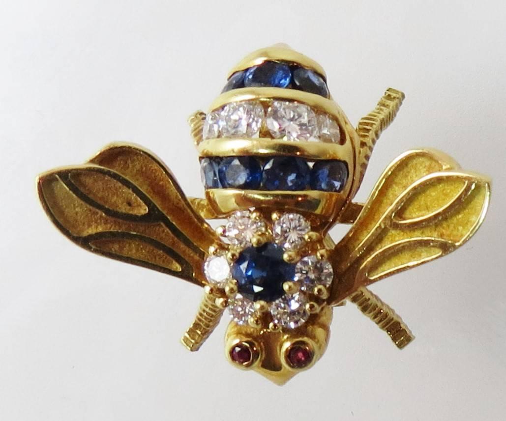 Rosenthal 18K yellow gold diamond and sapphire bee pin, set with 10 full cut round diamonds weighing .49cts and 8 round blue sapphires weighing .80cts and two 1.2mm round ruby eyes.