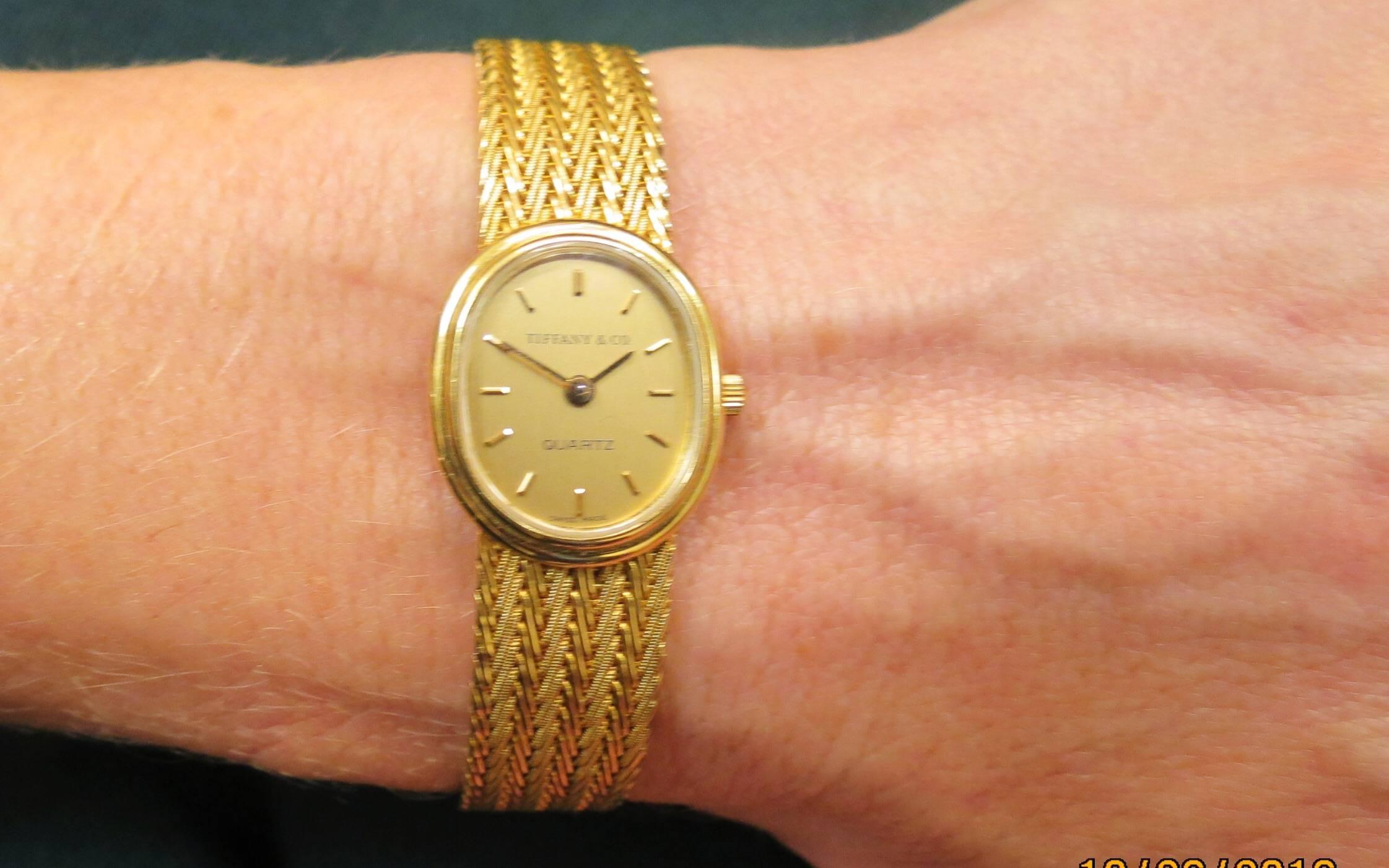 Tiffany & Co 18K yellow gold ladies oval bracelet watch, quartz movement, gold dial, stick markers, Tiffany & Co. on dial, pre-owned.

Bracelet length 6.38
Bracelet width .43
Case size 20mm x 16mm