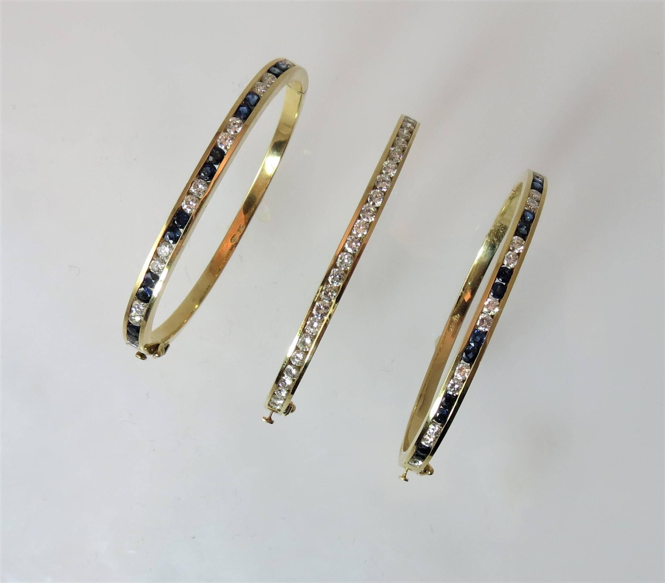 Set of three 18K yellow gold  hinged bangle bracelets:

Two 18K yellow gold hinged bangle bracelets, each set with 12 round blue sapphires weighing 1.54 cts and 12 full cut round diamonds weighing 1.20cts total, width 1/8 inch. Priced at $3500